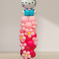 Balloon sculpture of a character with a pink and red base on a white background