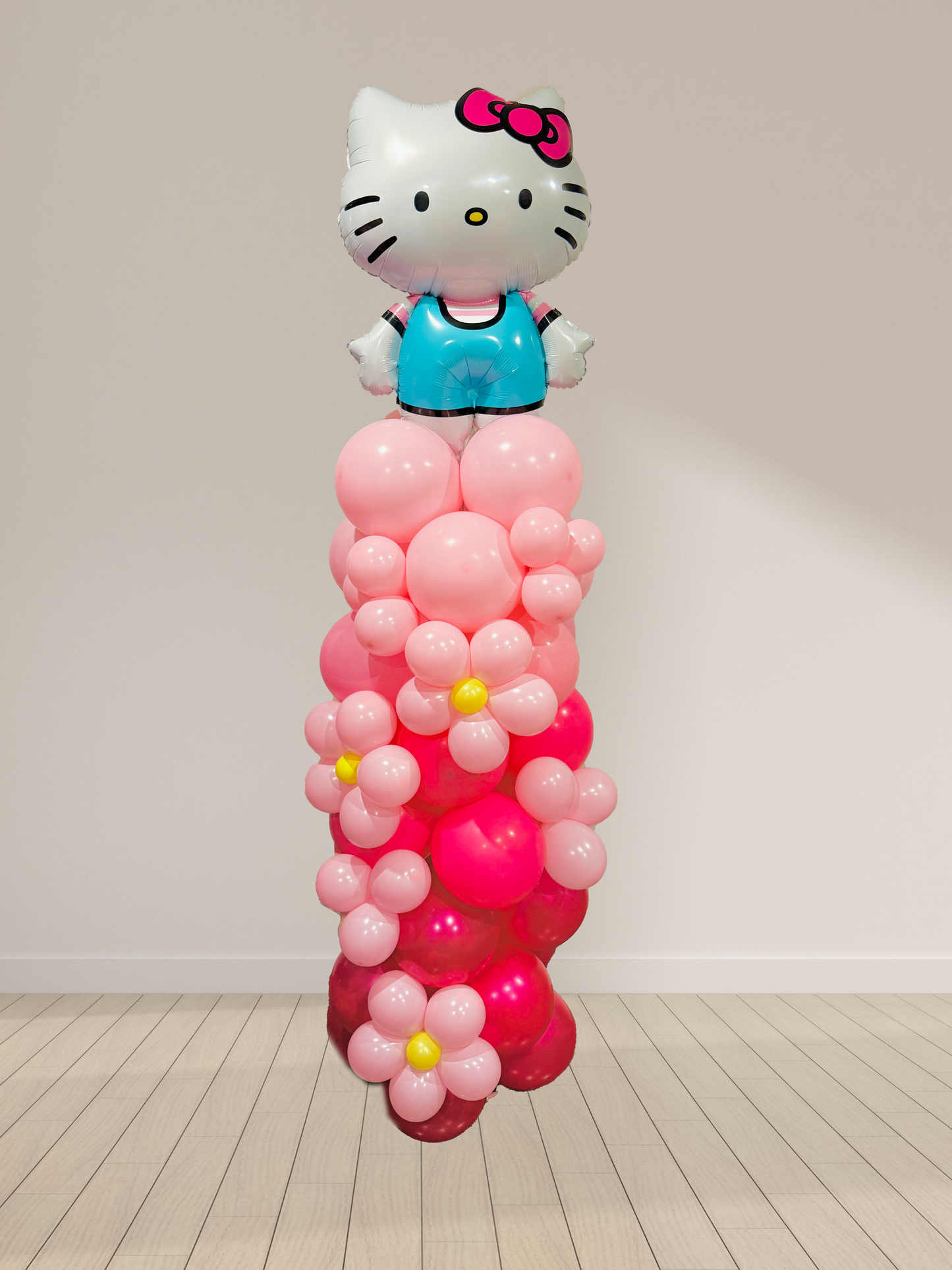 Balloon sculpture of a character with a pink and red base on a white background