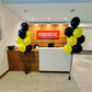 Front desk area with 'FOODTASTIC' sign and balloons in a modern interior setting