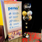 SYSCO Perks promotional banner with balloons on a carpeted floor.