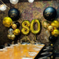 Decorated birthday table with balloons and 'Happy Birthday Dad!' text against a textured wall.