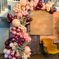 Luxury spring floral balloon garland with blush, gold, and greenery for elegant event decor.