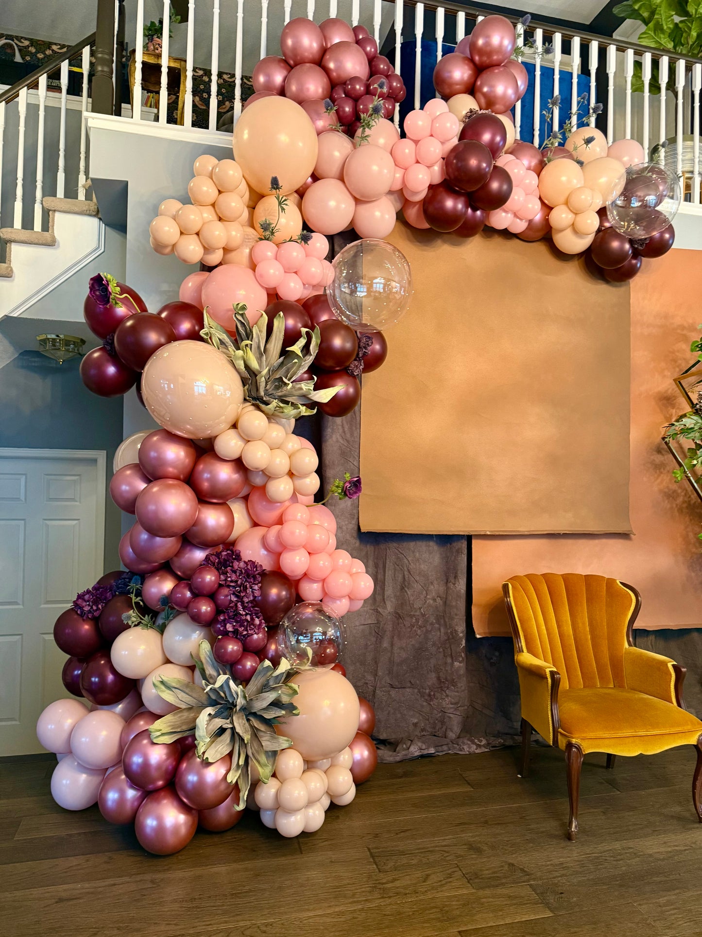 Luxury spring floral balloon garland with blush, gold, and greenery for elegant event decor.