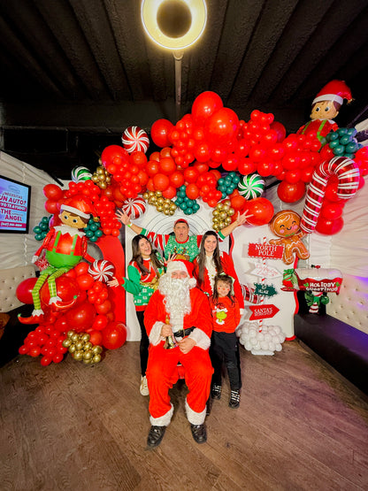 Christmas balloon decoration with elf balloons, candy cane props, and festive balloon garlands.