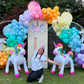 Magical Unicorn Balloon Backdrop with a pastel rainbow balloon arch and inflatable unicorn decorations for a kids’ party.