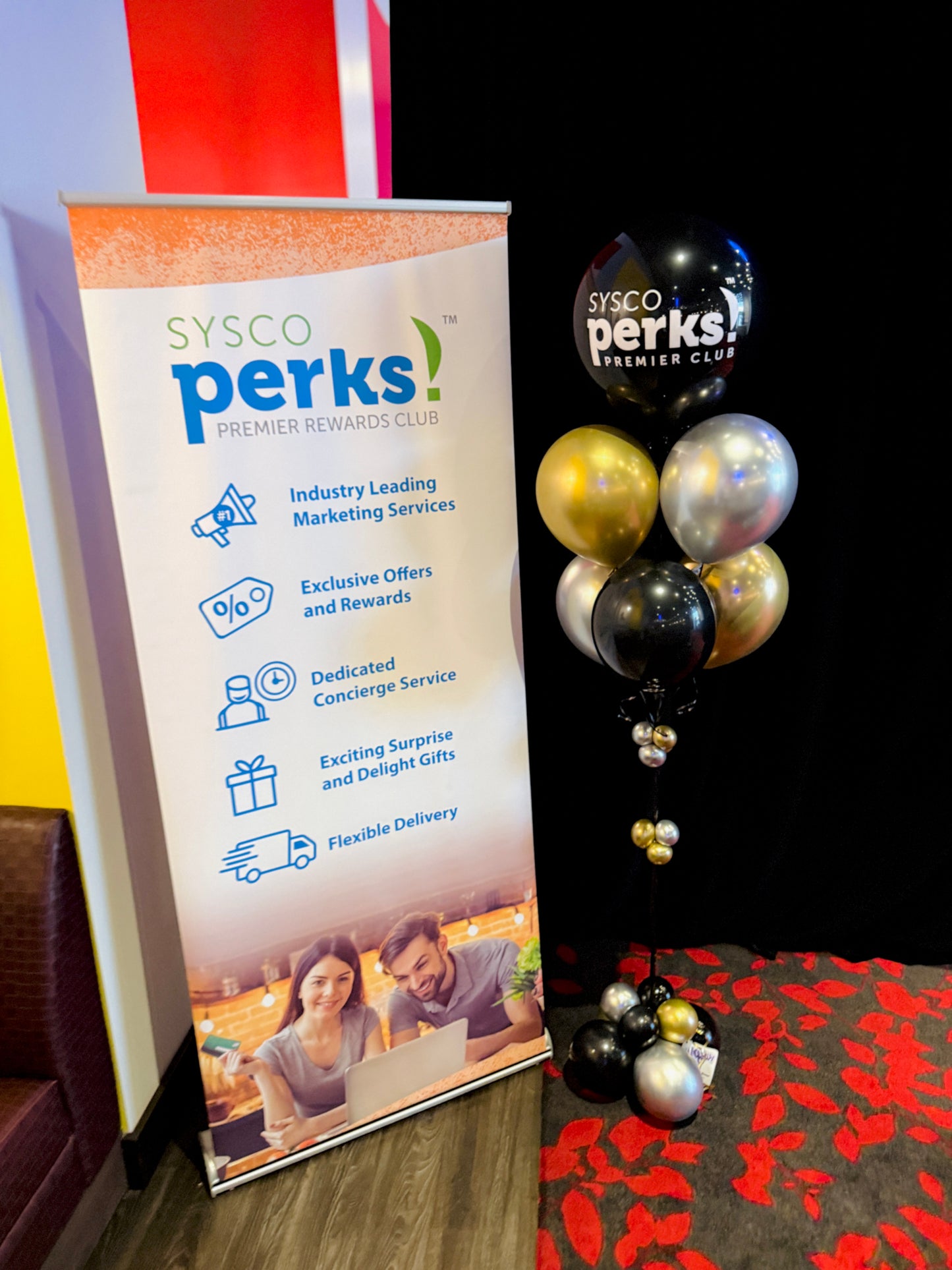SYSCO perks promotional banner with balloons on a table
