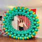Giant Christmas Balloon Wreath made with biodegradable balloons, customizable design, 10ft size with a red or gold bow.