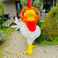 Balloon sculpture of a rooster in front of a house