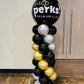 Balloon column with 'SYSCO Perks' branding on a wooden floor.