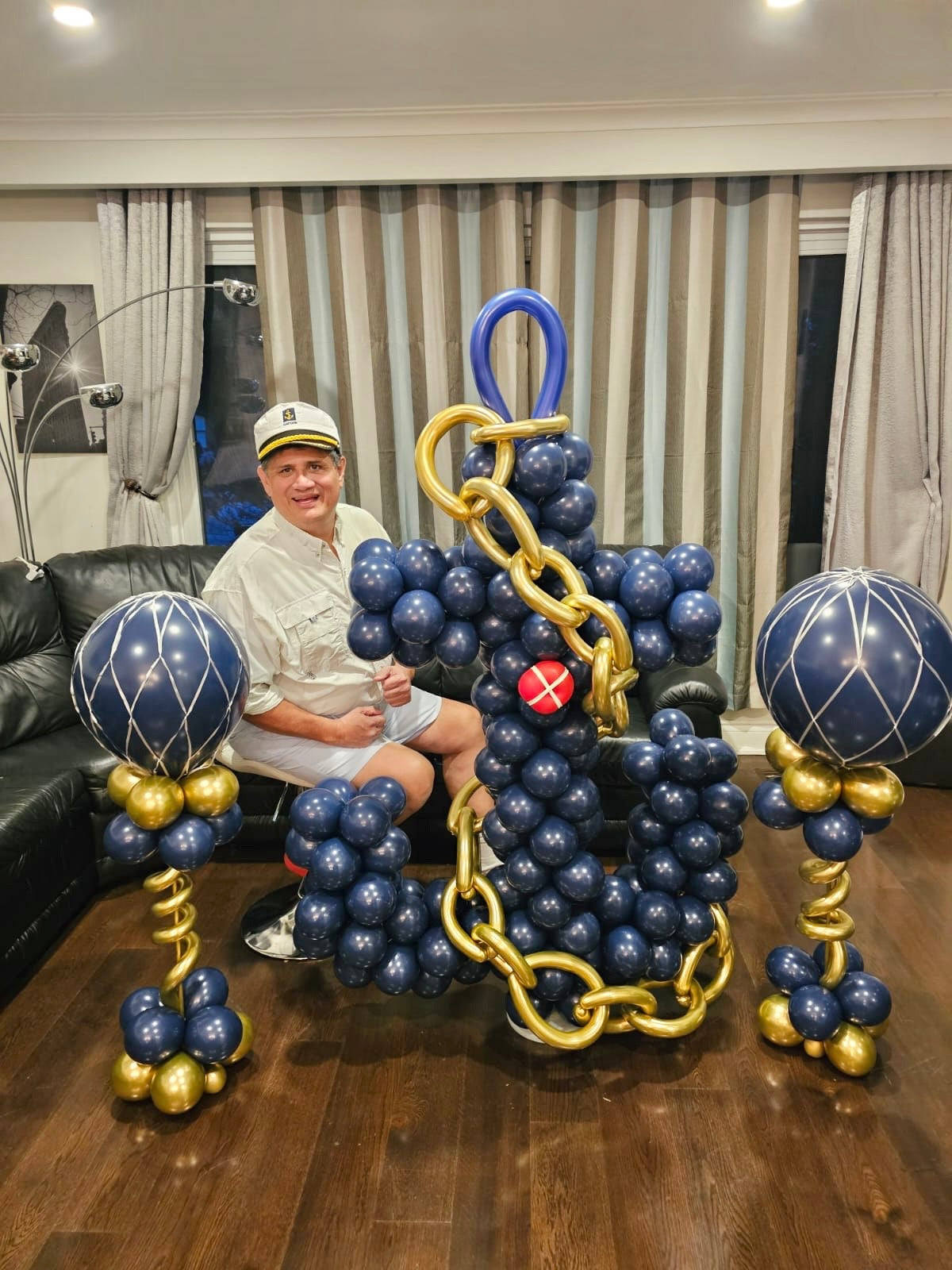 Freestanding Balloon Anchor Sculpture with navy, gold, and red biodegradable balloons.
