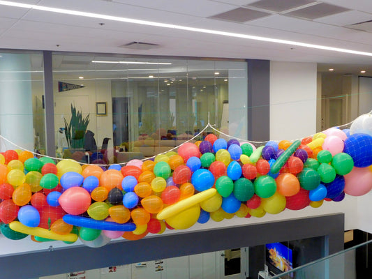 Overhead balloon drop with 360 colorful balloons for a spectacular celebration.
