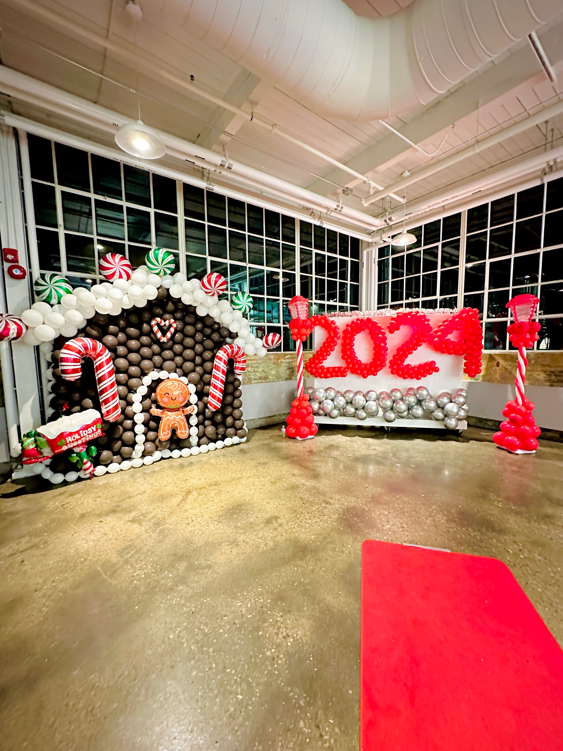 Gingerbread Balloon House with festive balloons and holiday decorations.