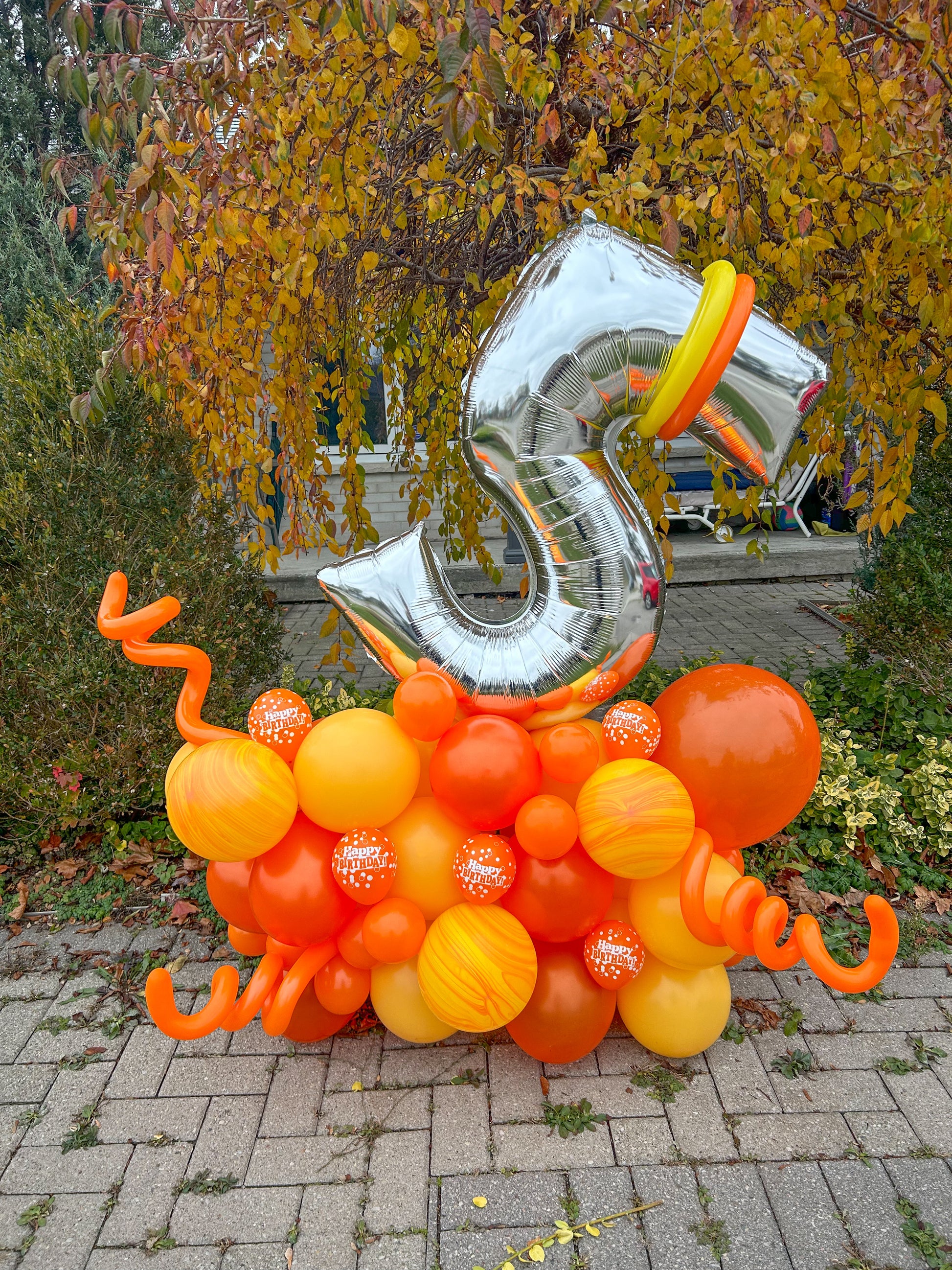 Birthday Number Balloon Arrangement with a silver number balloon and customizable balloon colors for a festive celebration.