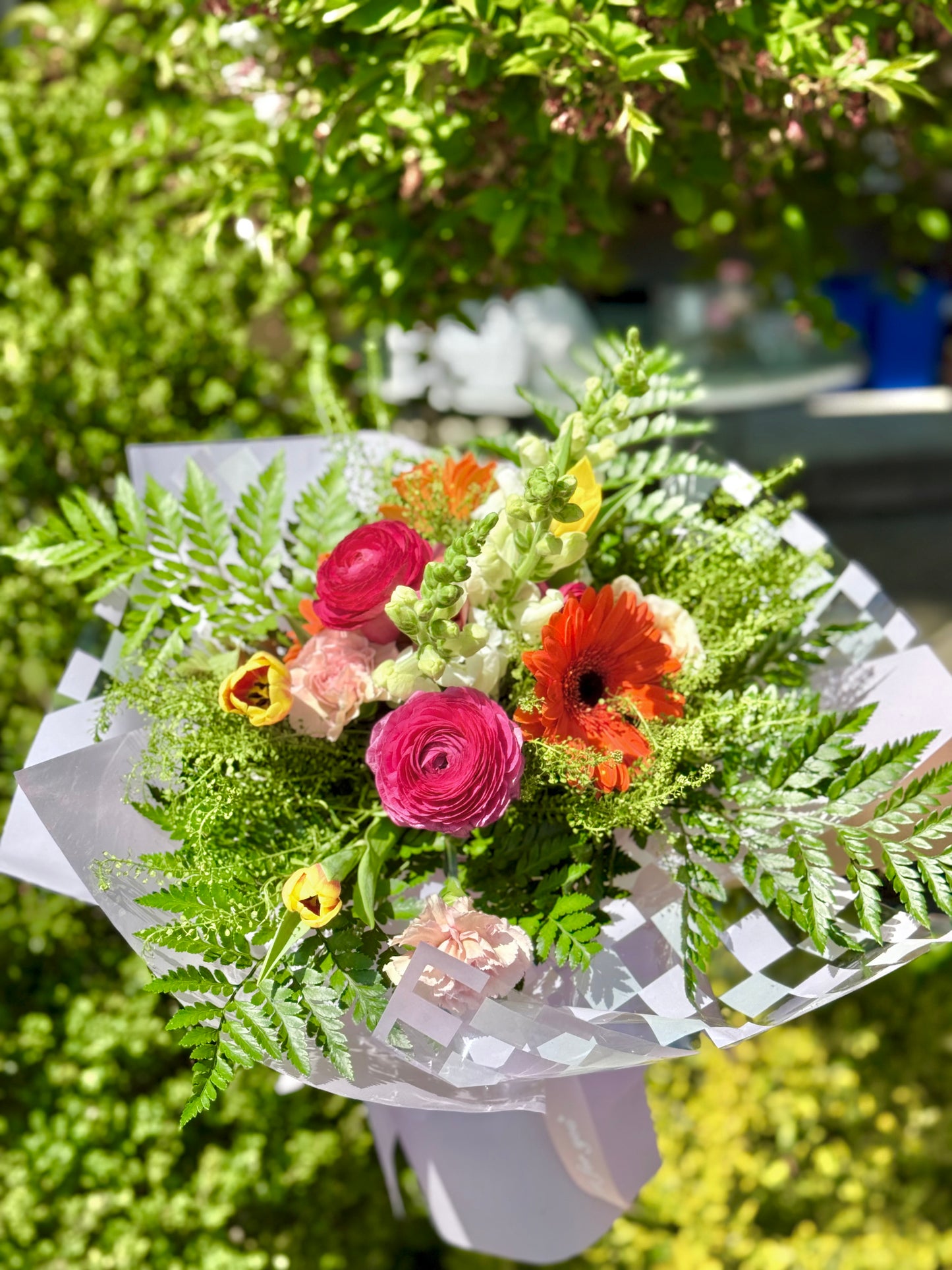Bouquet of flowers with greenery and purple wrapping paper made by wooow balloons for mother's day