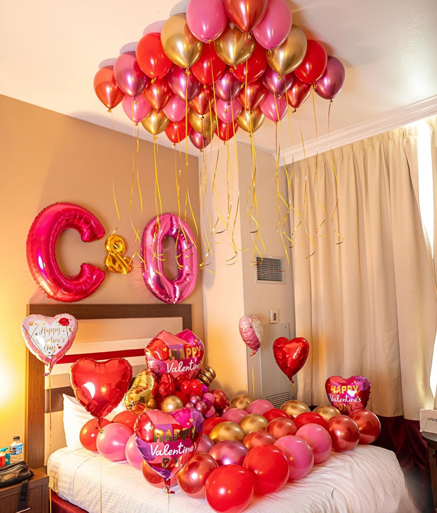 Romantic Love Decor – Elegant balloon setup with personalized initials, ceiling balloons, and heart-shaped balloons