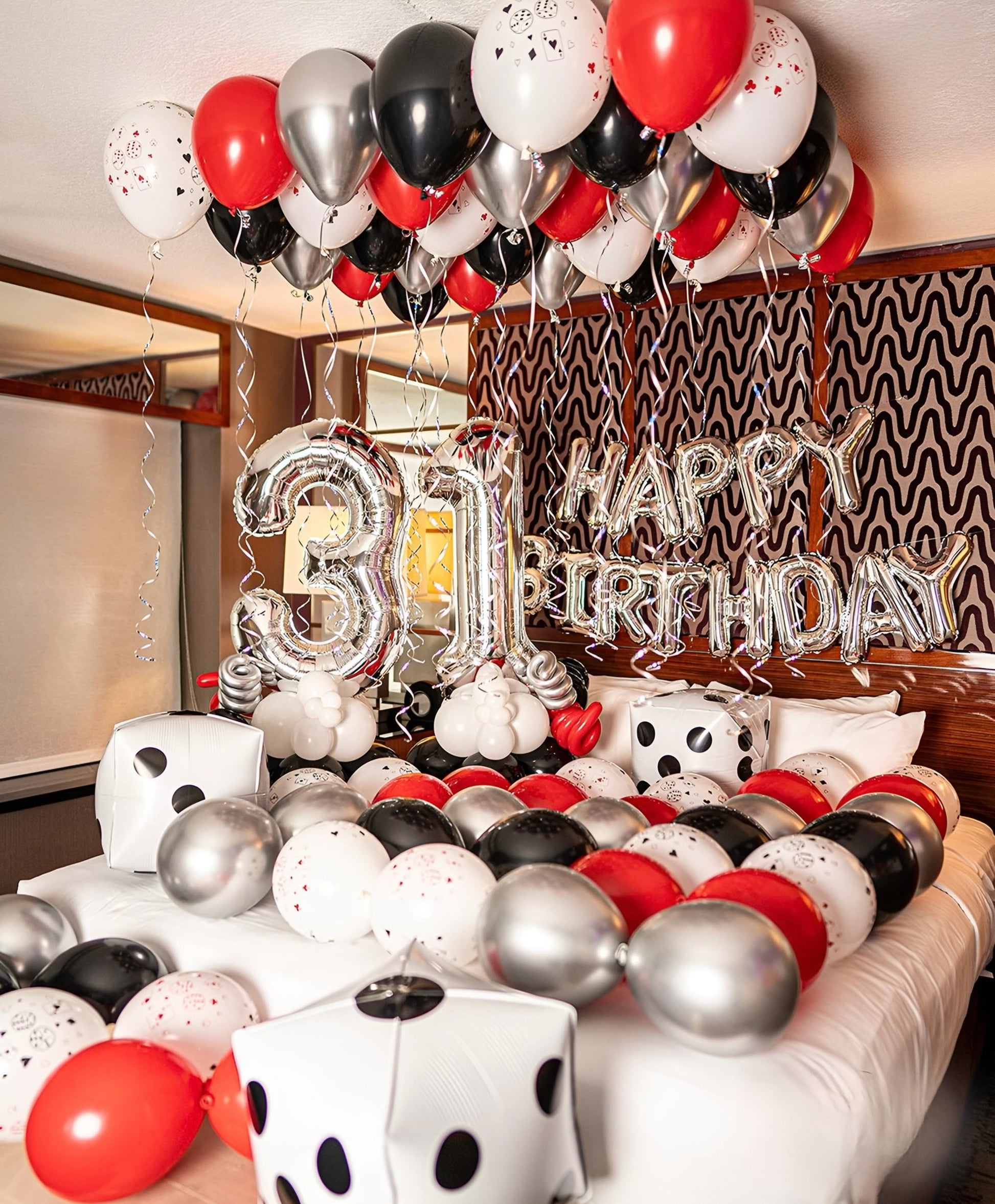 Casino Decor with helium balloons, dice foils, “Happy Birthday” banner, and number stands for a fun celebration.