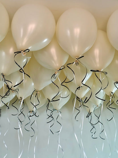 Coquette Balloons with helium-filled biodegradable balloons and decorative bows.

