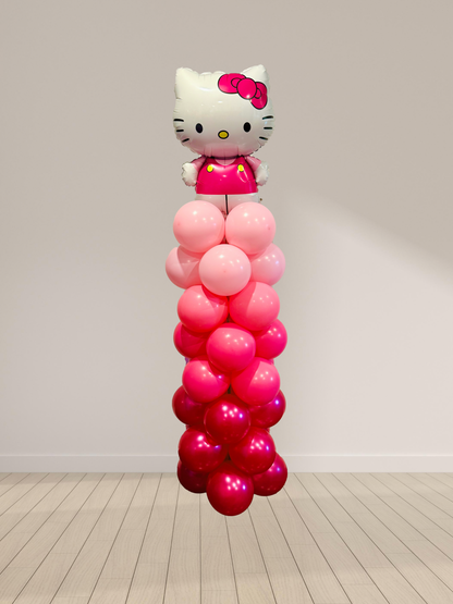 Balloon column with Hello Kitty figure against a plain background