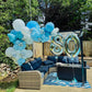 Outdoor setting with blue and white balloons and '80' balloons on a patio.