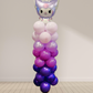 Balloon sculpture with a character on top against a plain background