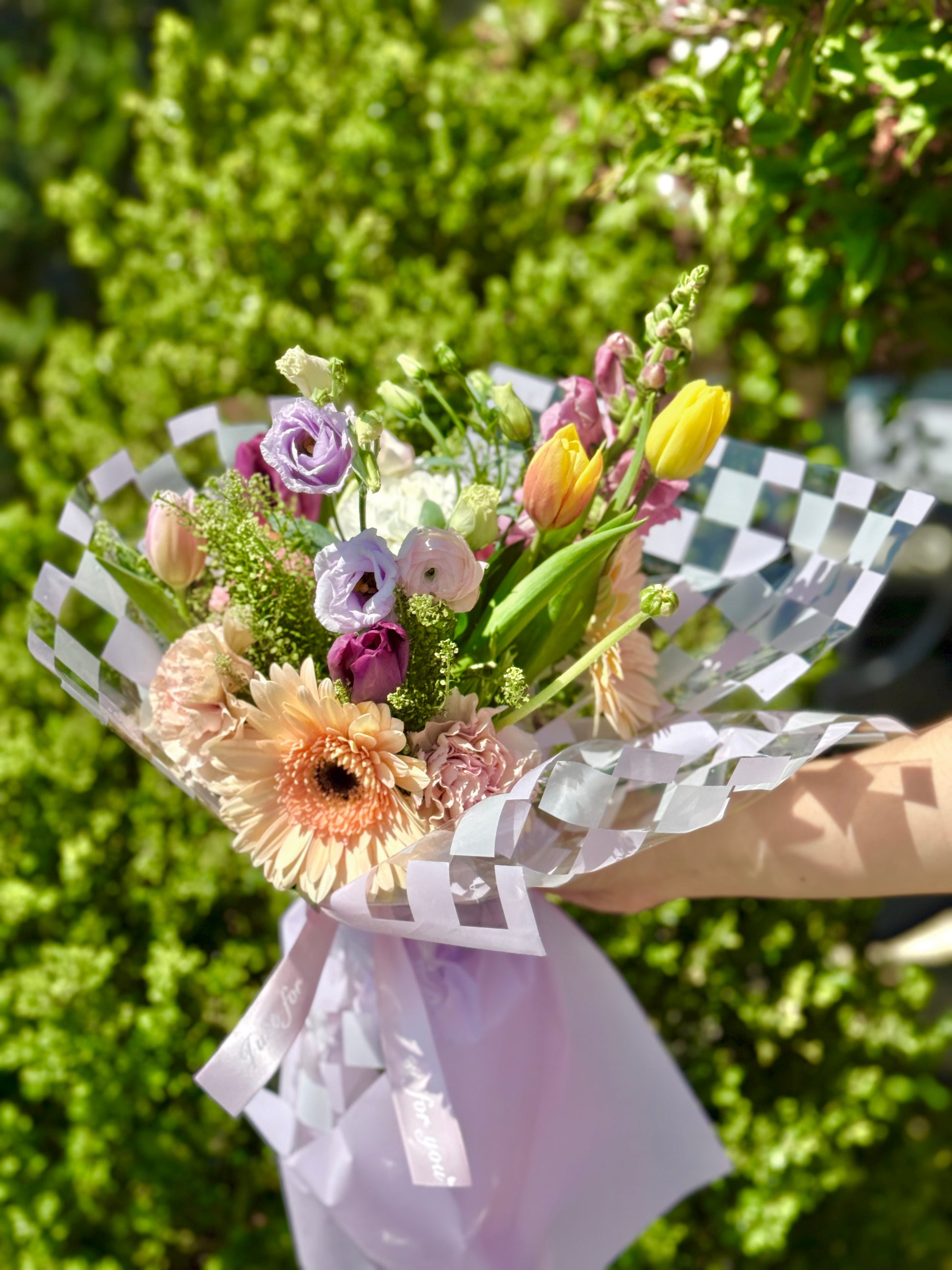 Bouquet of flowers wrapped in checkered paper for Mom.