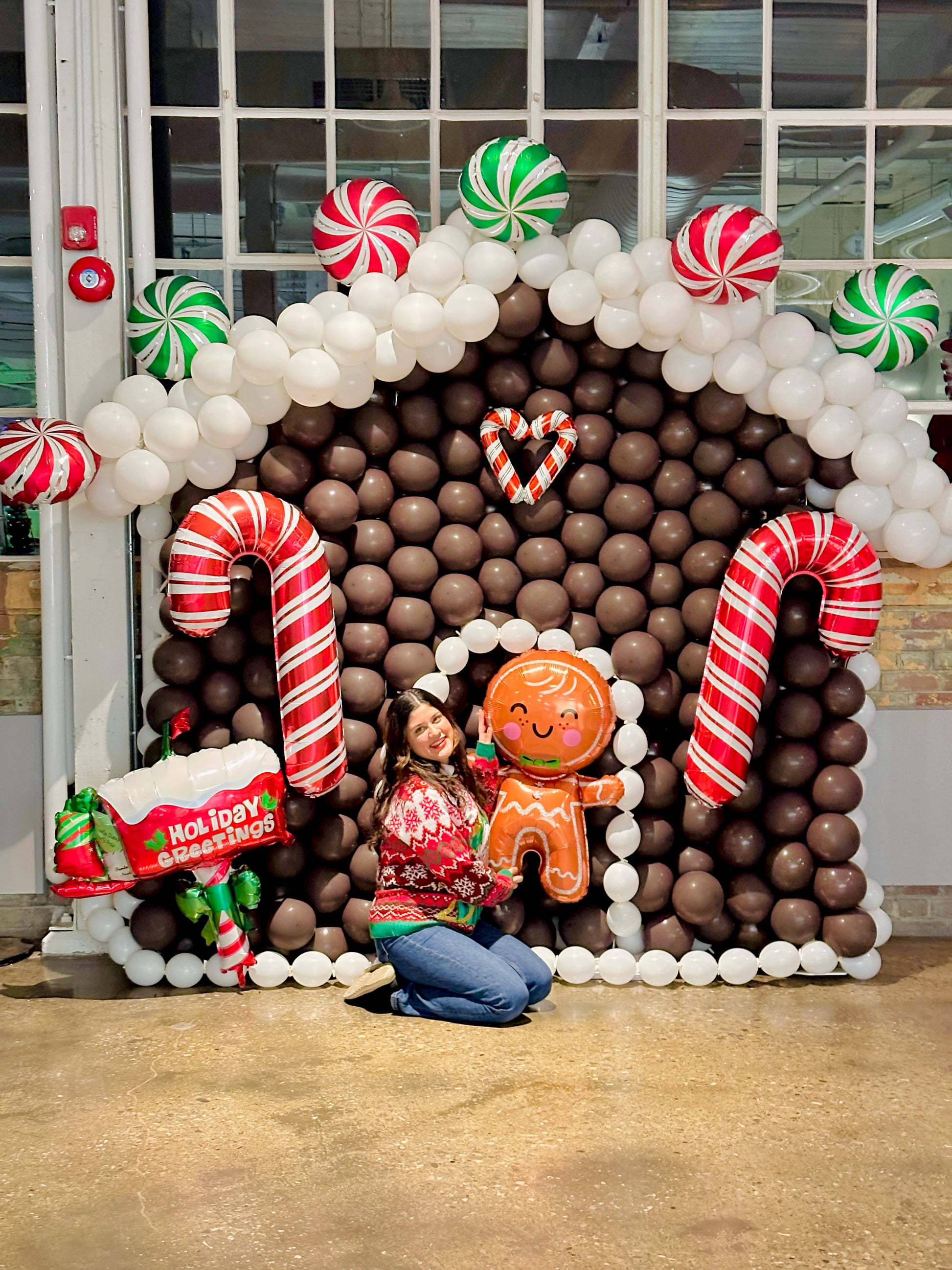 Gingerbread Balloon House with festive balloons and holiday decorations.
