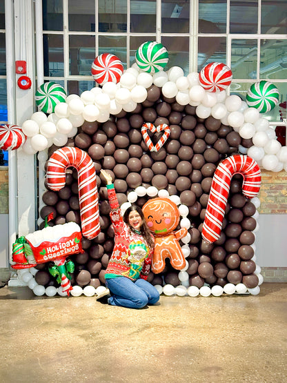 Gingerbread Balloon House with festive balloons and holiday decorations.