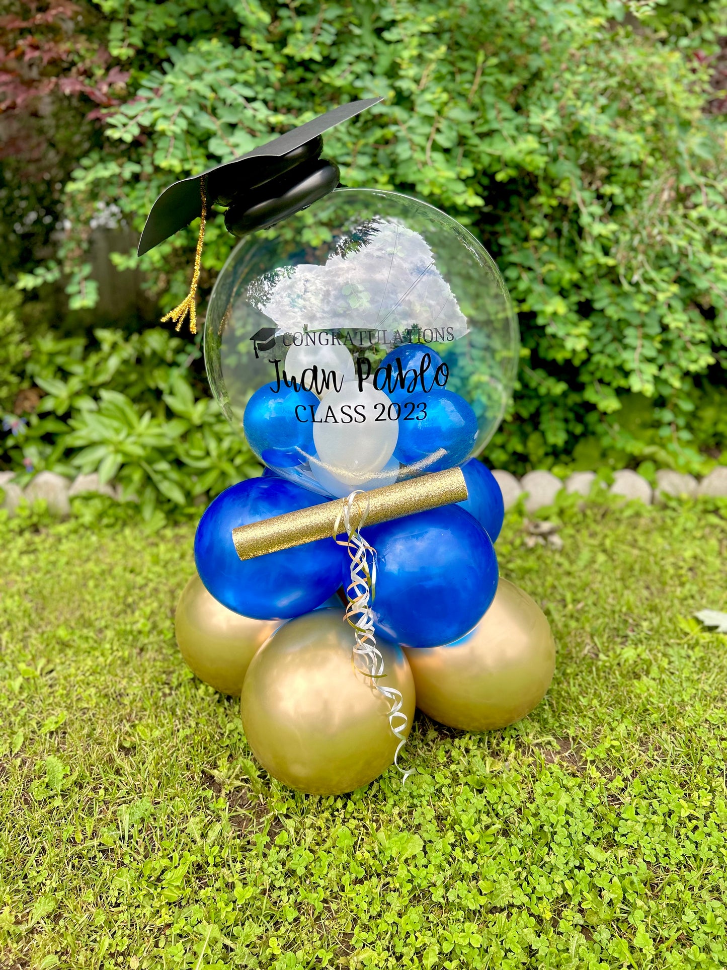 Graduation Balloon Gift with clear bobo balloon, mini balloons, diploma, and grad cap decoration.