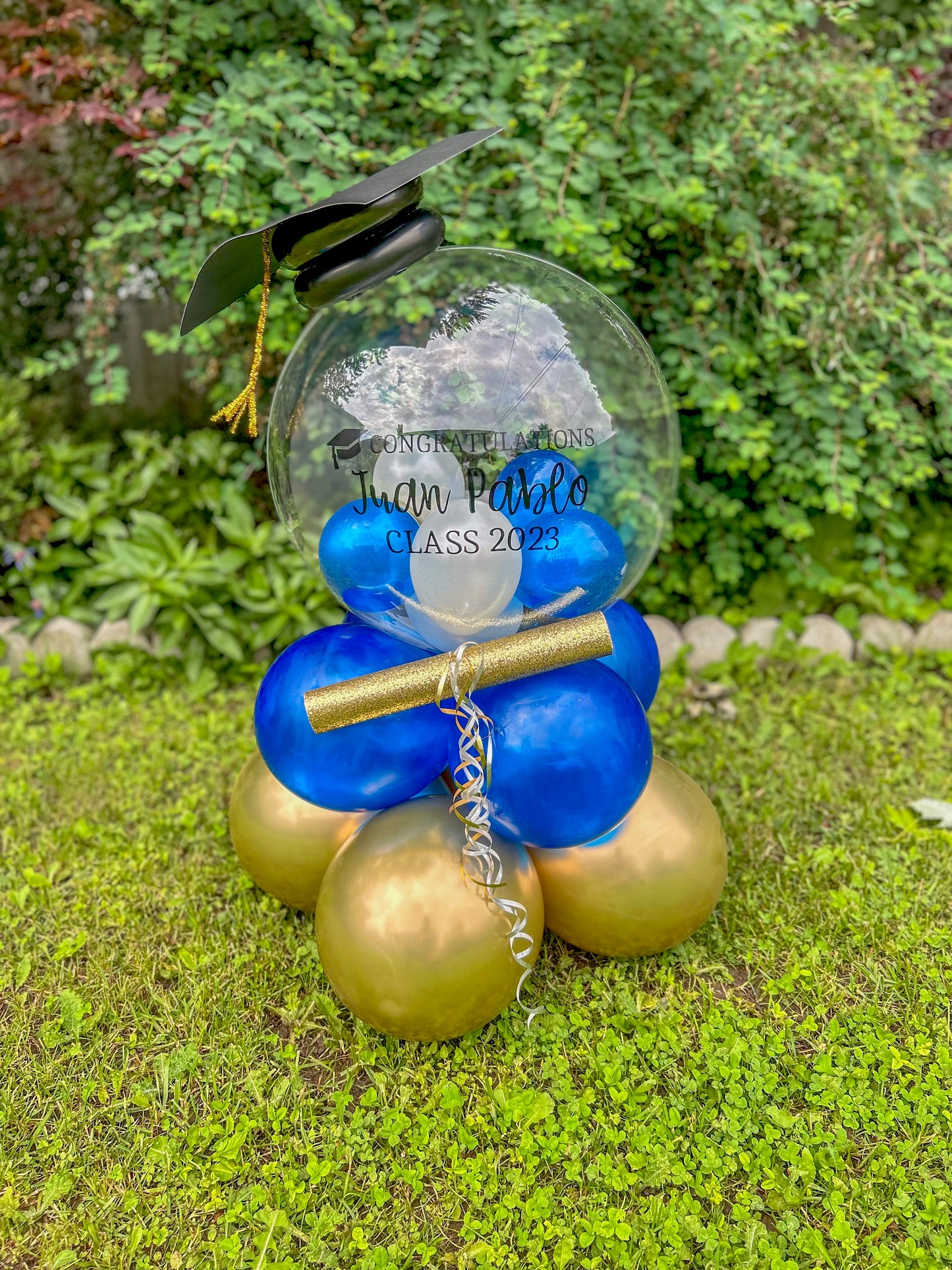 Graduation Balloon Gift with clear bobo balloon, mini balloons, diploma, and grad cap decoration.