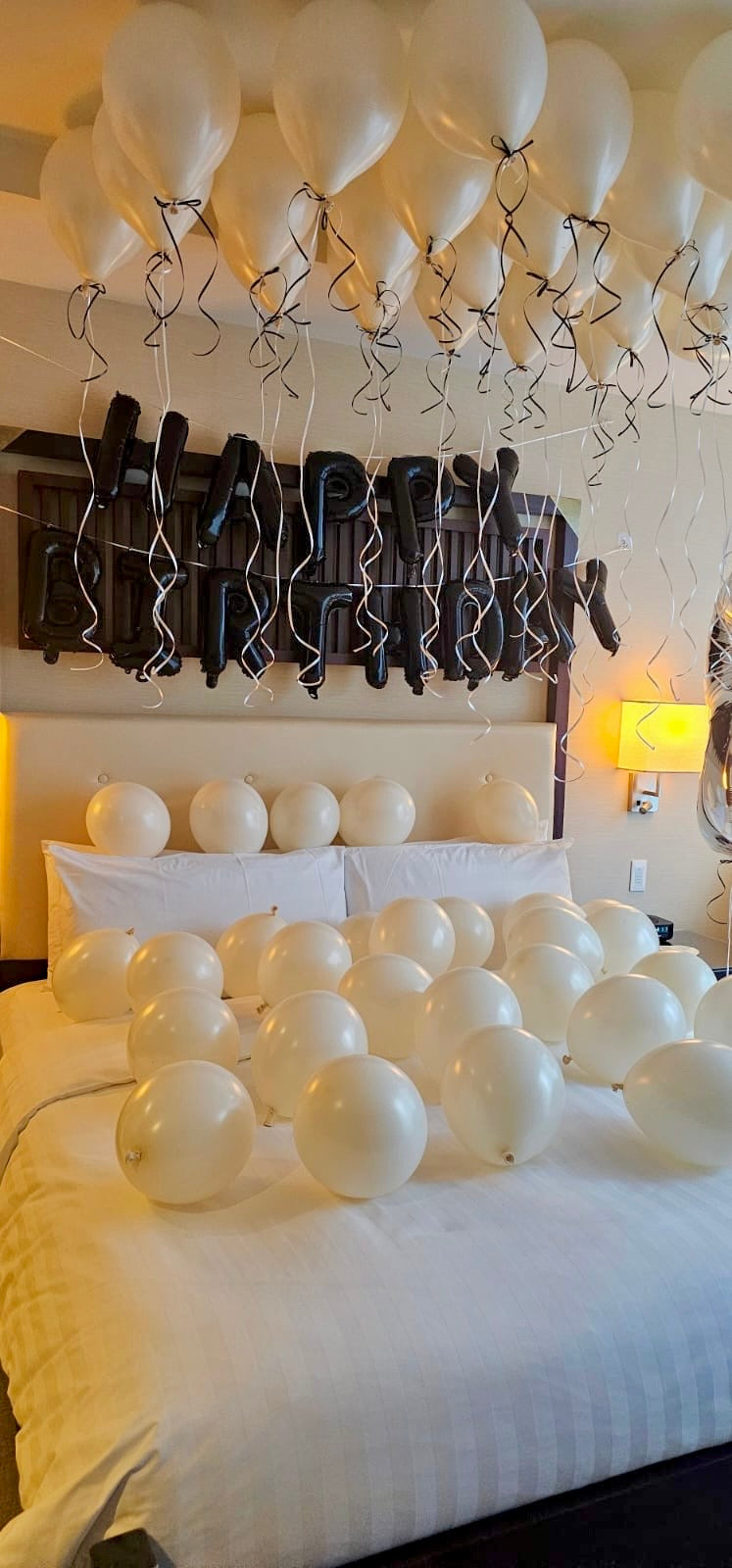 Creamy Blush Birthday Room Decor with helium balloons, banner, and number stands.
