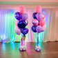 Birthday Balloon Bouquets Toronto – Pink and purple helium balloons with a cute baby at a colorful party setup by Wooow Balloons Toronto.