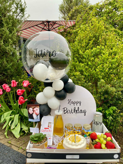 Breakfast Surprise Box filled with assorted pastries, fresh fruit, a cake, and customizable items to brighten the morning.