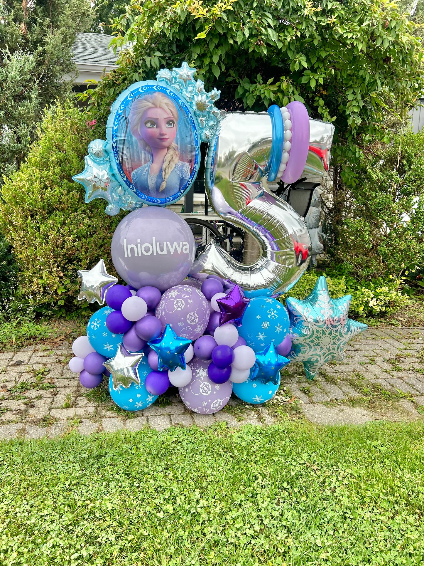 Frozen-themed balloon arrangement with Elsa and number balloon for a birthday celebration.