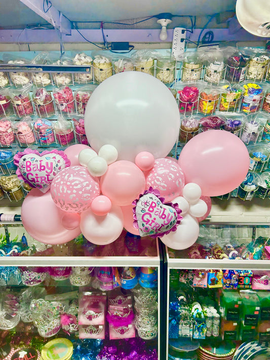 Baby Girl Balloon Garland featuring pastel pink, white, and metallic tones with a mix of heart-shaped foil and latex balloons