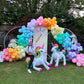 Magical Unicorn Balloon Backdrop with a pastel rainbow balloon arch and inflatable unicorn decorations for a kids’ party.