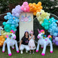 Magical Unicorn Balloon Backdrop with a pastel rainbow balloon arch and inflatable unicorn decorations for a kids’ party.