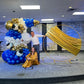 Luxury Soccer Balloon Backdrop with a gold arch, blue and white balloon arrangement, and soccer-themed decorations for a sports event.