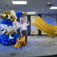 Luxury Soccer Balloon Backdrop with a gold arch, blue and white balloon arrangement, and soccer-themed decorations for a sports event.