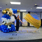 Luxury Soccer Balloon Backdrop with a gold arch, blue and white balloon arrangement, and soccer-themed decorations for a sports event.