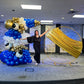 Luxury Soccer Balloon Backdrop with a gold arch, blue and white balloon arrangement, and soccer-themed decorations for a sports event.