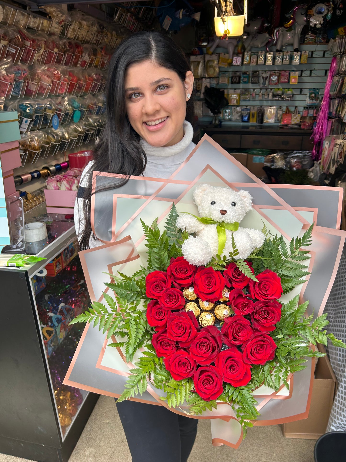 Heart-shaped bouquet with fresh red roses, Ferrero Rocher chocolates, and a teddy bear.