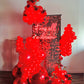 Luxury Red Shimmery Wall Balloon Installation with a red sequin wall, premium balloon garland, LED neon sign, florals, and mirror balls for an elegant event setup.