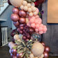 Luxury spring floral balloon garland with blush, gold, and greenery for elegant event decor.