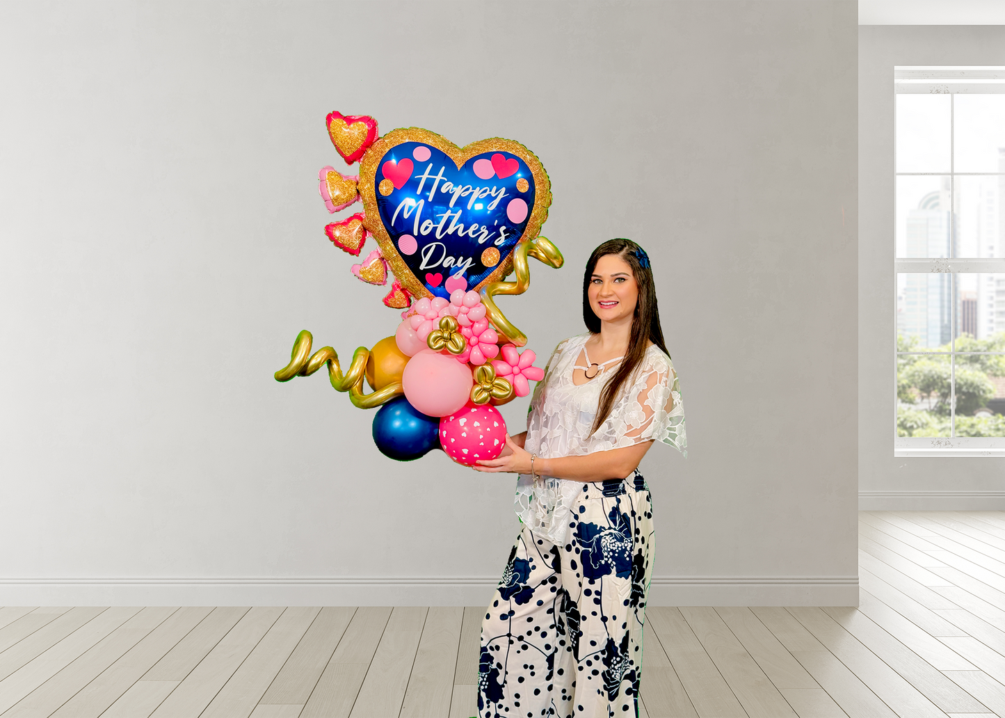 Balloon heart stand for Mother’s Day with blue heart, mini pink hearts, floral accents, and hand-shaped base