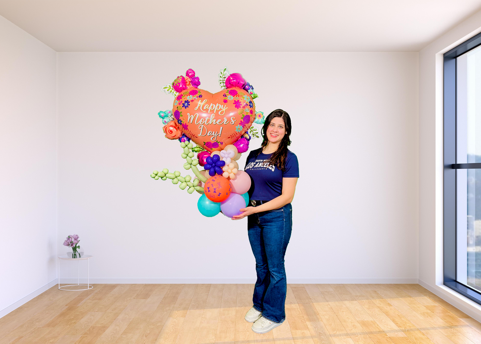 Mother’s Day balloon stand with heart balloon, lavender twisting shapes, mini flowers, and hand-styled balloon base