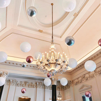 Suspended Floating Balloon Installation with giant and orbz balloons in a stunning event venue.