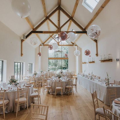 Suspended Floating Balloon Installation with giant and orbz balloons in a stunning event venue.