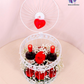 Romantic Cage Gift Set with fresh roses, baby’s breath flowers, and wine bottles inside an elegant white metal birdcage.