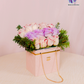 Luxury Bloom Purse with fresh white and lavender roses in a pink quilted handbag-inspired box.