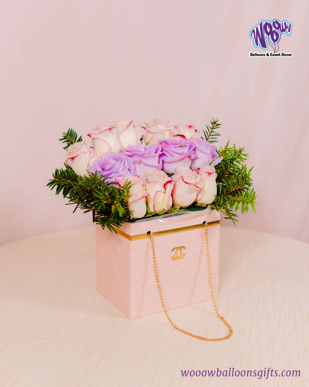 Luxury Bloom Purse with fresh white and lavender roses in a pink quilted handbag-inspired box.